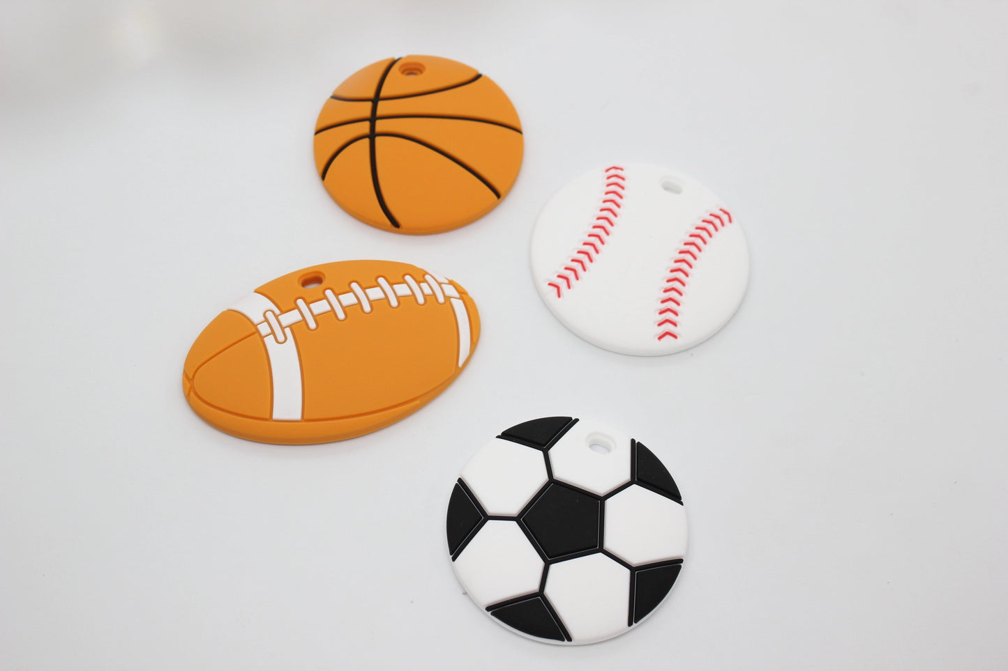 Sports themed silicone teethers